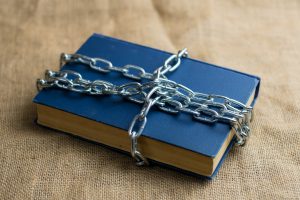 An image of a book with a chain around it
