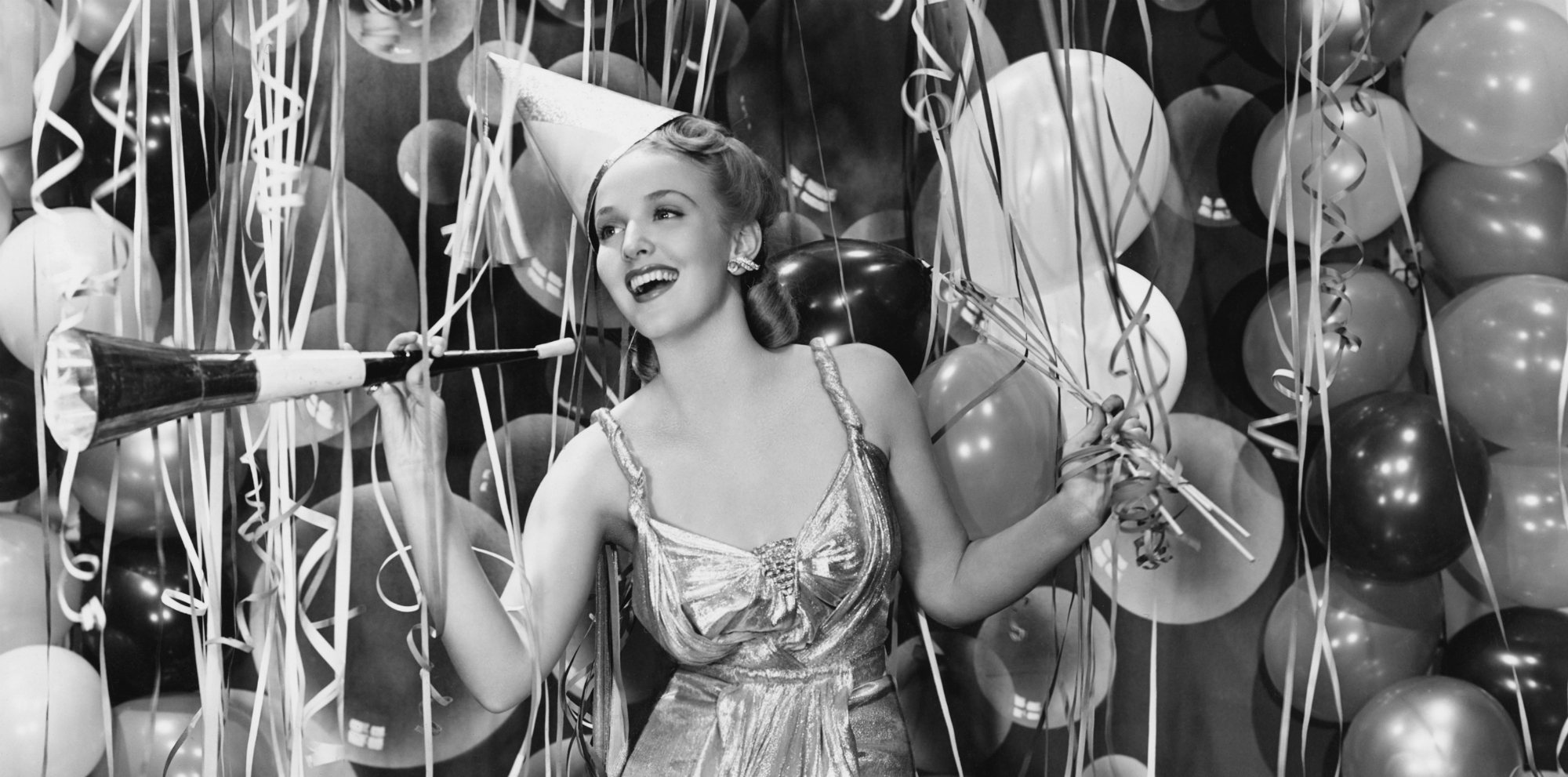 Retro image of girl having a party, with balloons in the background